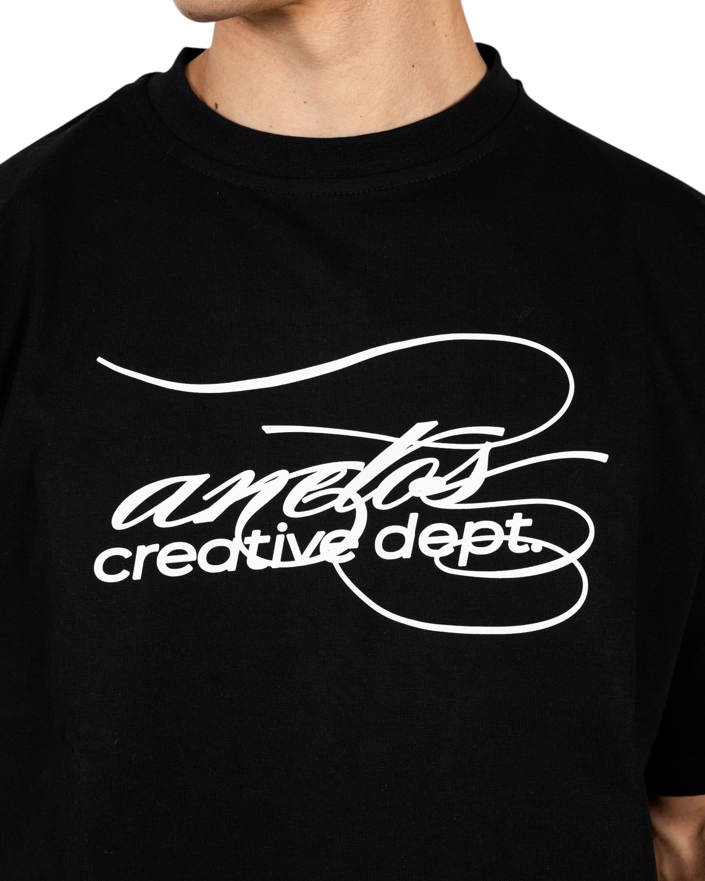 Anetos black cotton t-shirt with white 'creative dept.' graphic print. Crew neck, short sleeves.