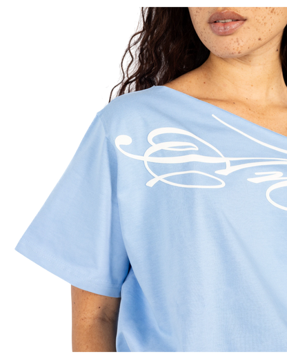Anetos baby blue cotton off-shoulder top with white graphic print. Short sleeves, relaxed fit.