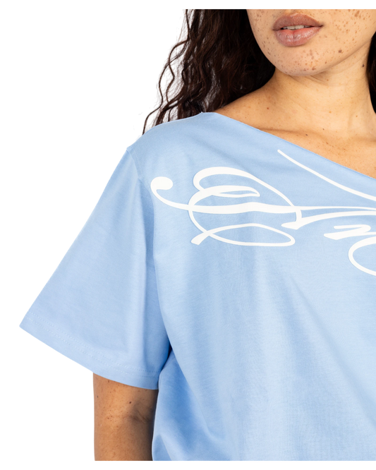 Anetos baby blue cotton off-shoulder top with white graphic print. Short sleeves, relaxed fit.