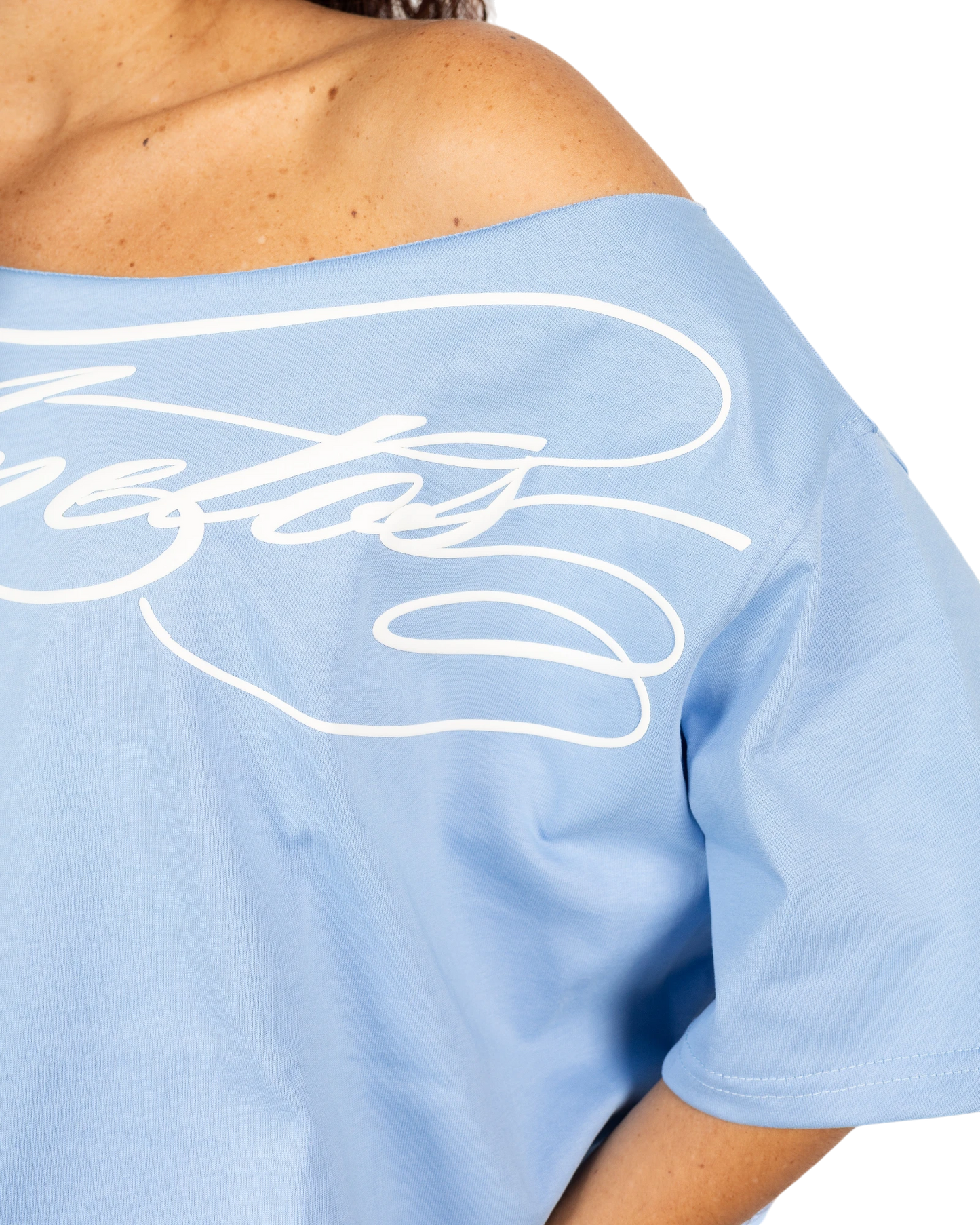 Anetos baby blue cotton off-shoulder top with white script logo detail. Relaxed fit, perfect for casual or dressy occasions.