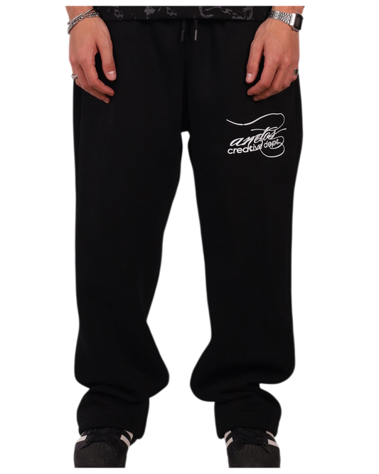 Anetos black cotton sweatpants with white embroidered logo on the left thigh. Relaxed fit, drawstring waist, and cuffed ankles.