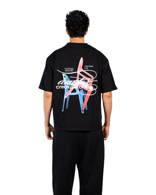 Anetos black cotton t-shirt with a graphic print of two chairs and text "creative dept".