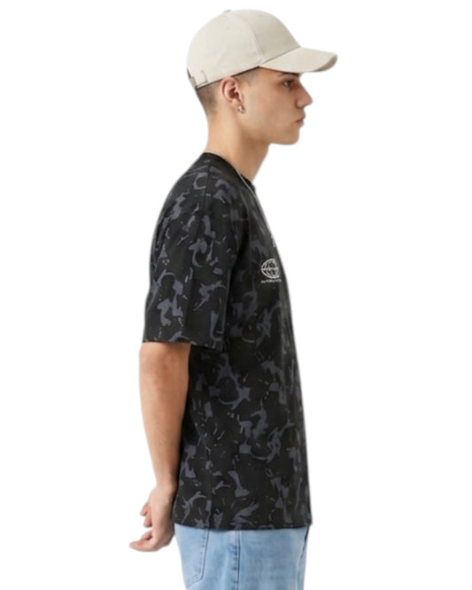 Anetos Blackout Camo Tee: black t-shirt with a grey camouflage pattern, short sleeves, and a relaxed fit, worn by a male model.