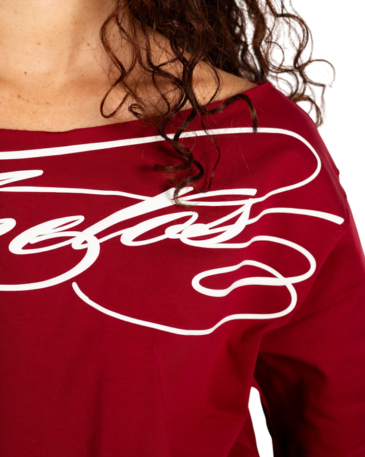 Anetos burgundy off-shoulder top with white signature graphic print. Soft cotton blend.
