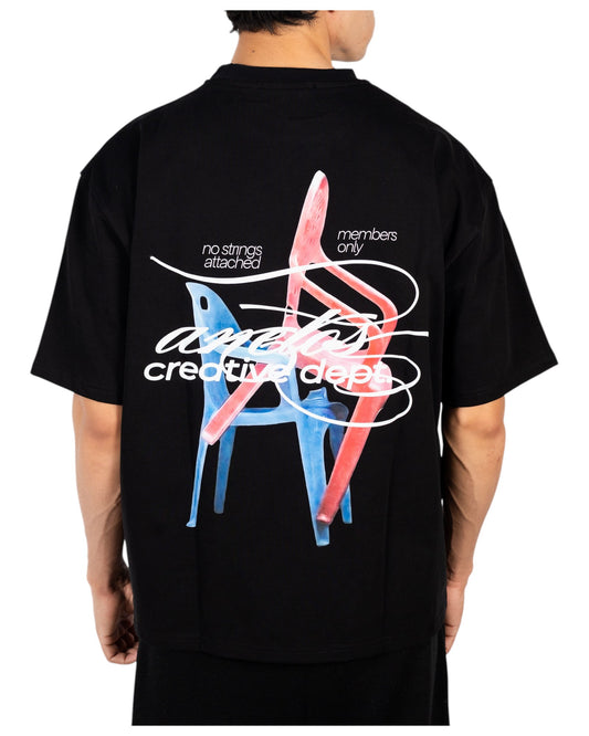 Anetos black cotton t-shirt with a graphic print of two chairs, one blue and one red, with text "no strings attached members only anetos creative dept".