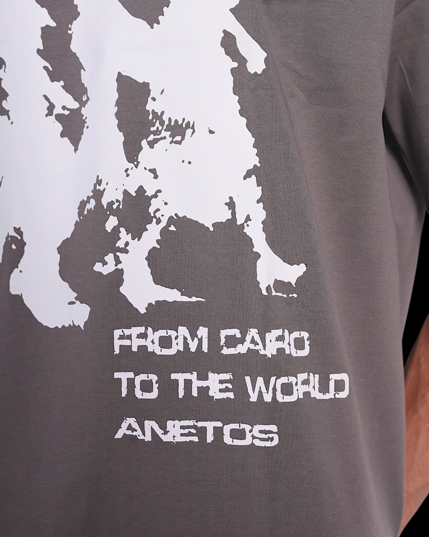 Anetos grey cotton t-shirt with white 'From Cairo To The World' graphic print and brand name.
