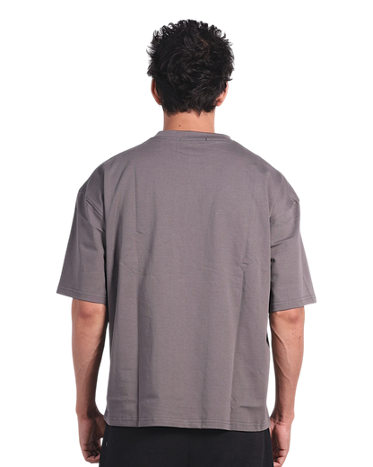 Anetos grey cotton t-shirt with short sleeves and black trousers, worn by a man from behind.