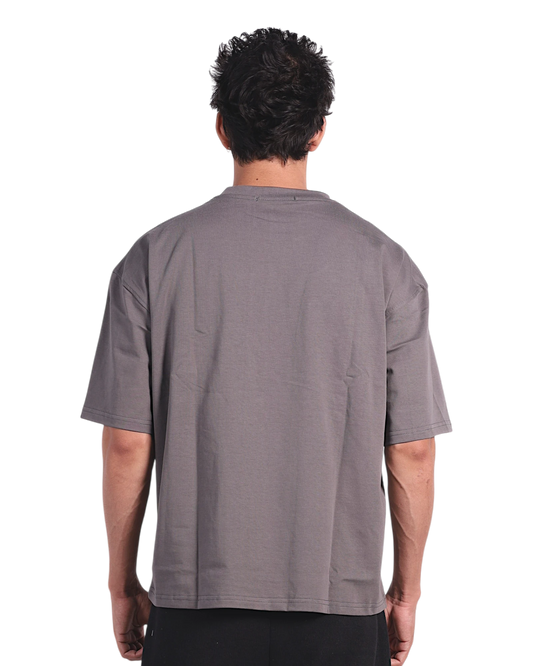 Anetos grey cotton t-shirt with short sleeves and black trousers, worn by a man from behind.