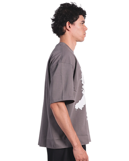 Anetos grey cotton t-shirt with a white graphic print, worn by a man with black pants and shoes.