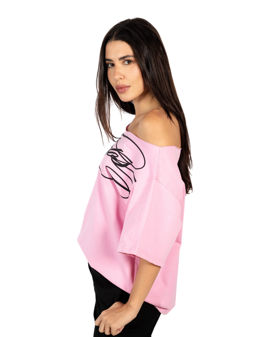 Anetos pink off-shoulder top with black graphic print. Comfortable and elegant, perfect for casual or special occasions.