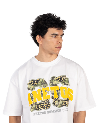 Anetos white cotton t-shirt with a graphic print featuring yellow text and camouflage/leopard pattern.