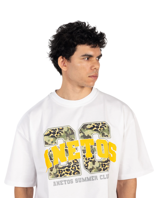 Anetos white cotton t-shirt with a graphic print featuring yellow text and camouflage/leopard pattern.